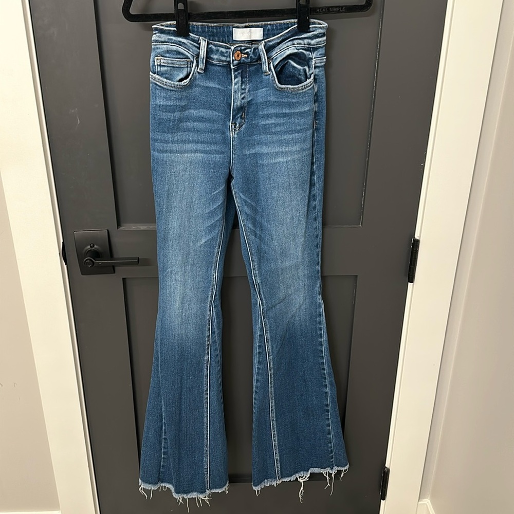 Flare jeans with distressed bottoms